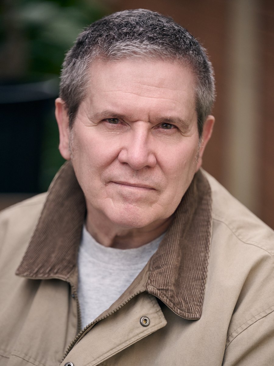 Blair Purvis, a man in his sixties with short grey hair, in a tan jacket with a brown corduroy collar.